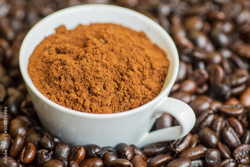 Closeup of a cup filled with coffee powders Closeup of a cup filled with coffee powders
