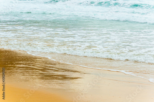 sea coast with rough seas, waves on a sandy beach, beautiful landscape in summer