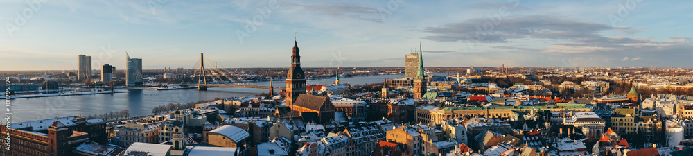 Wide panorama of Riga. Aerial view of Riga center from St. Peter's Church, Riga, Latvia. Riga Cathedral and Daugava River in the background. Famous Landmark at sunset.