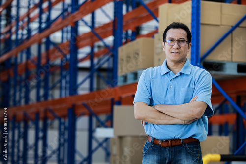 Asian man owner mananger of SME business warehouse storage