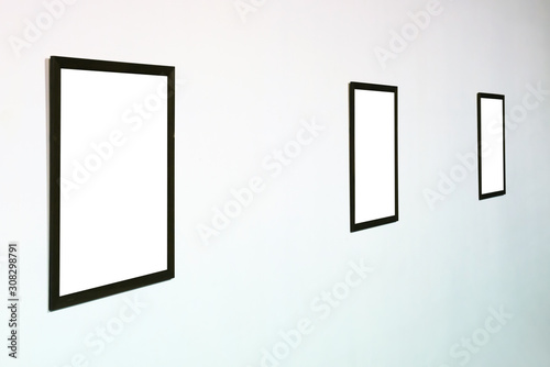 Empty blank picture wooden isolated frame in interior on white wall
