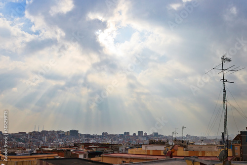 Sunrays through the clouds over Santa Coloma de Gramenet, Barcelona photo