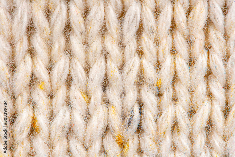 Texture of Wool Knit Beige Fabric Interspersed with Yellow Yarn. Sweater Background Close-Up View Texture of Wool Knit Beige Fabric Interspersed with Yellow Yarn. Sweater Background Close-Up View