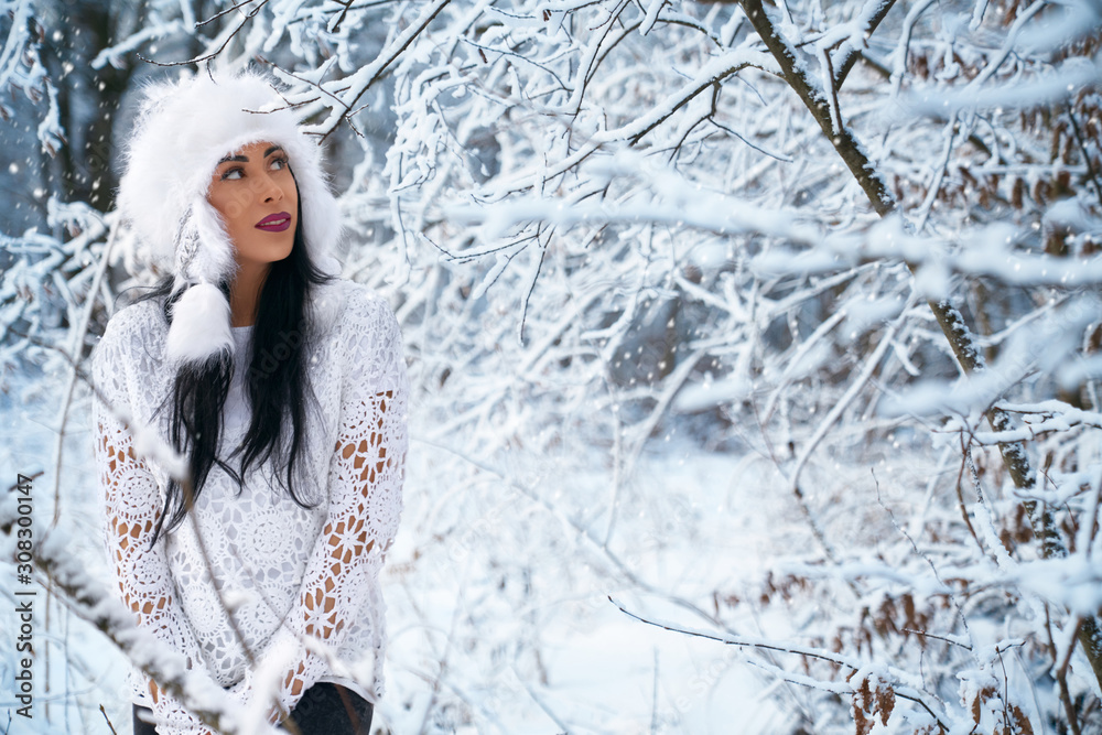 Girl in stylish warm hat, knitted blouse in winter forest. Girl in stylish warm hat, knitted blouse in winter forest.