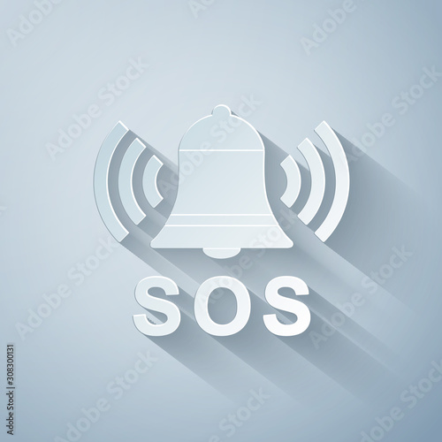Paper cut Alarm bell and SOS lettering icon isolated on grey background. Warning bell, help sign. Emergency SOS button. Paper art style. Vector Illustration