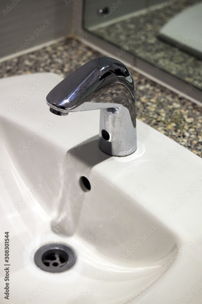 Fototapeta premium White bathroom sink and tap