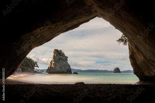 The famous view through the cathedral cave to the beach with the big rock in the back - Location: Coromandel, New Zealand - longexposure photography