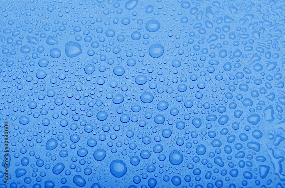 Water drops on a classic blue background. Top view. Trendy color of the year