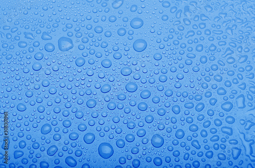 Obraz na płótnie Water drops on a classic blue background. Top view. Trendy color of the year w salonie