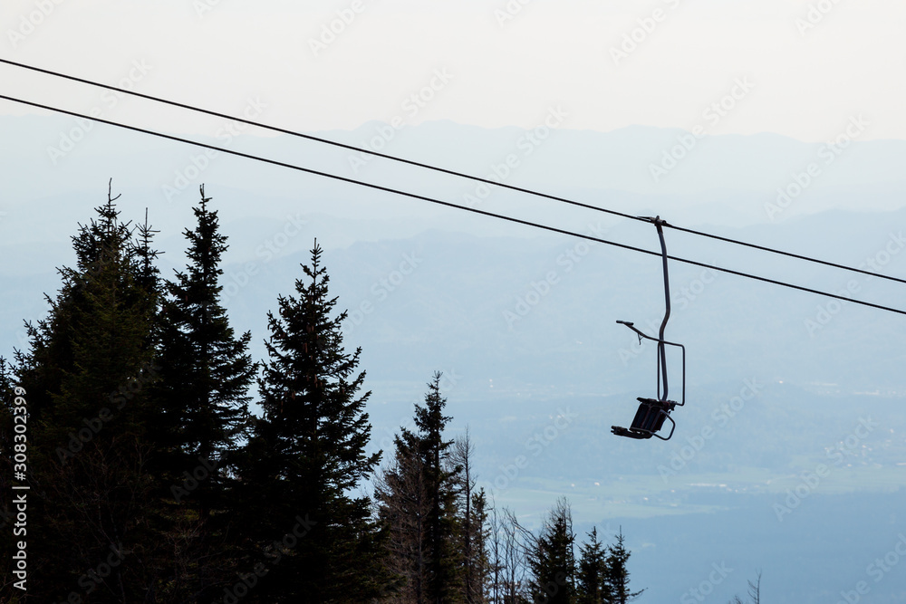 Chair lift on bright spring day on a mountain hill