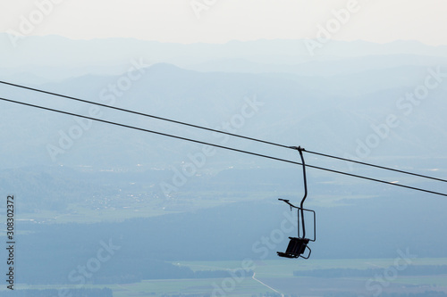 Chair lift on bright spring day on a mountain hill