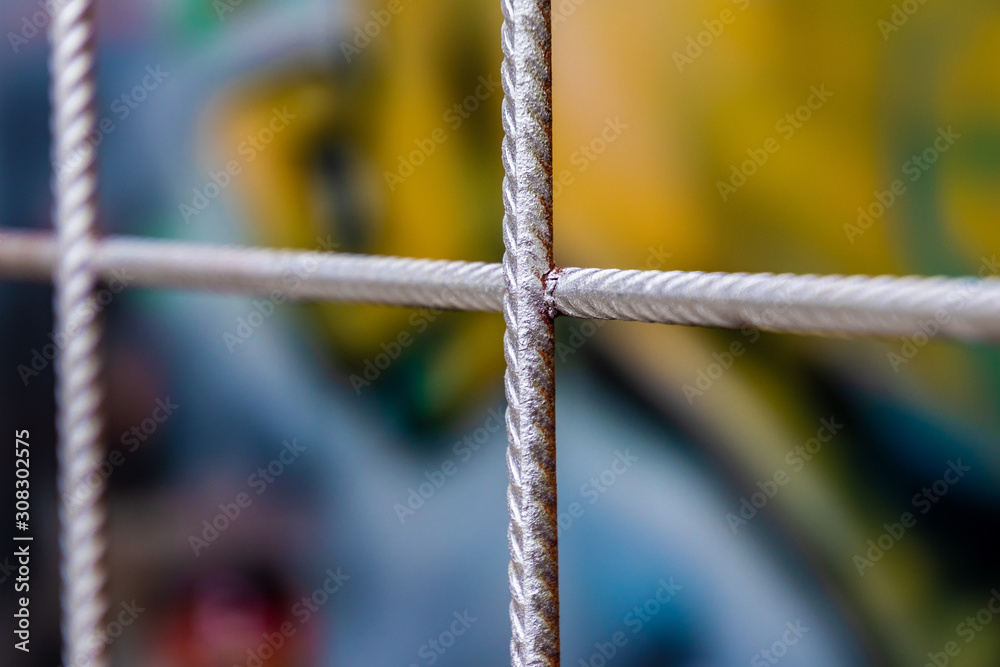 A steel fence at a construcktion side with colorful background A steel fence at a construcktion side with colorful background
