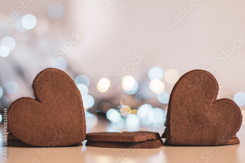 Macro close-up of tasty, heart shaped Christmas gingerbread cookies and bokeg christmas light bubble background. Shallow depth of field. photo