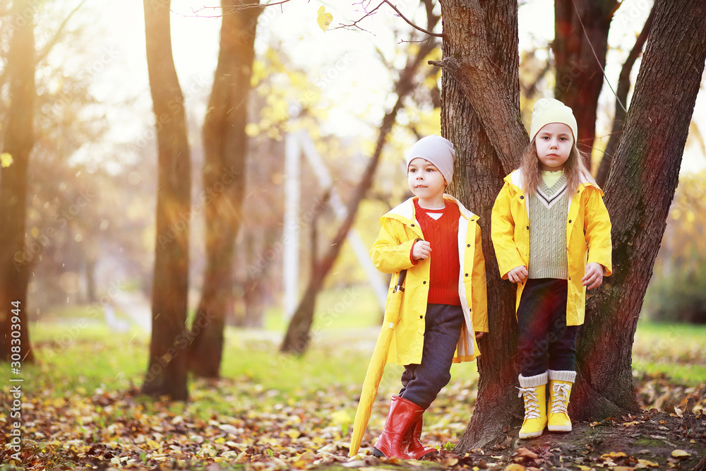Children walk in the autumn park Children walk in the autumn park