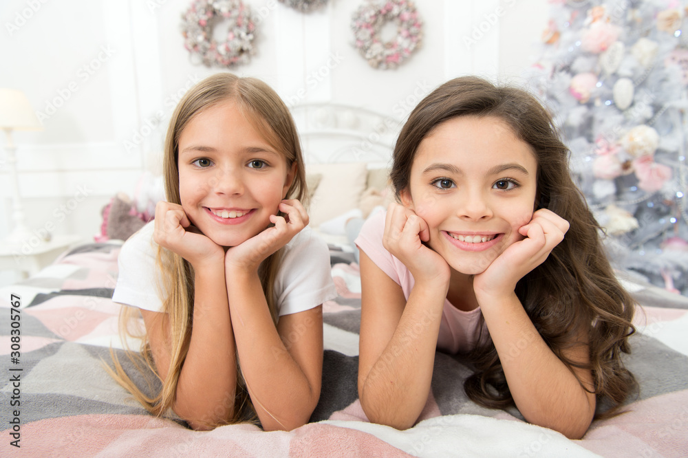 Happiness lives here. Happy children smile on bed. Small girls enjoy happiness on xmas eve. Childhood happiness. Emotional health. Happy childhood. Choose happiness. Holiday season in family circle Happiness lives here. Happy children smile on bed. Small girls enjoy happiness on xmas eve. Childhood happiness. Emotional health. Happy childhood. Choose happiness. Holiday season in family circle
