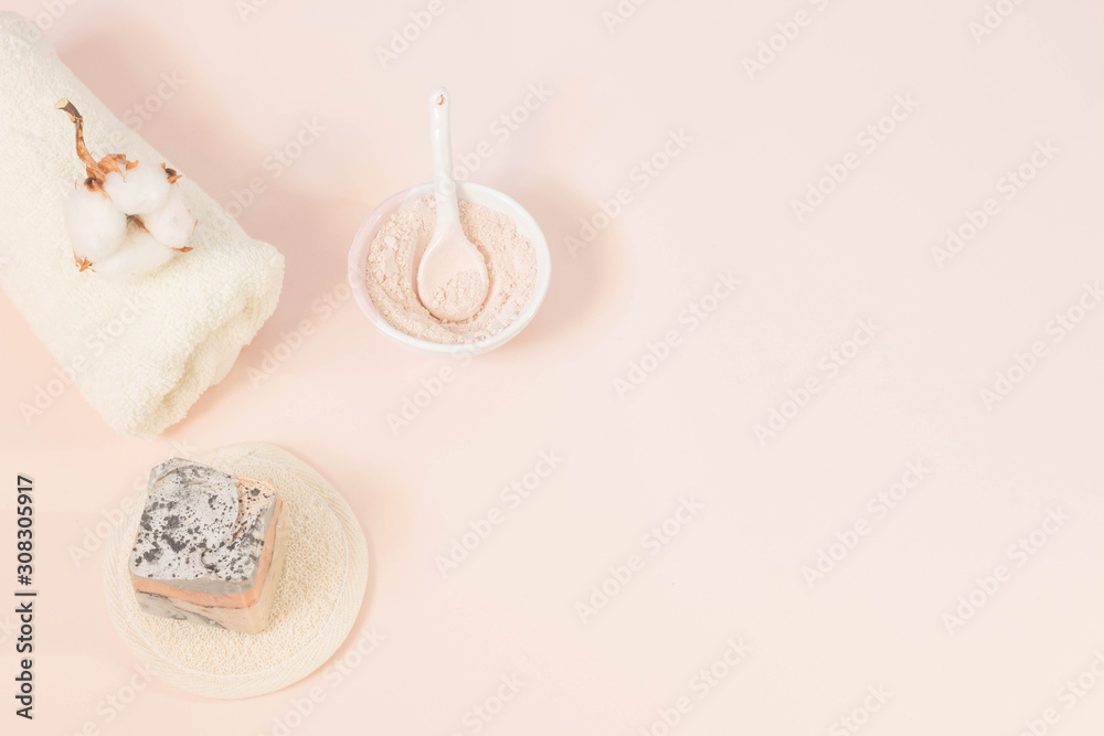 Spa beauty skin care minimal concept creative lay out composition made of clay and rose cleansing mask handmade soap cotton flower soft towel pink background with copy space top view Spa beauty skin care minimal concept creative lay out composition made of clay and rose cleansing mask handmade soap cotton flower soft towel pink background with copy space top view