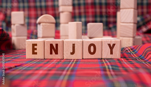 Word "Enjoy" written with wooden blocks