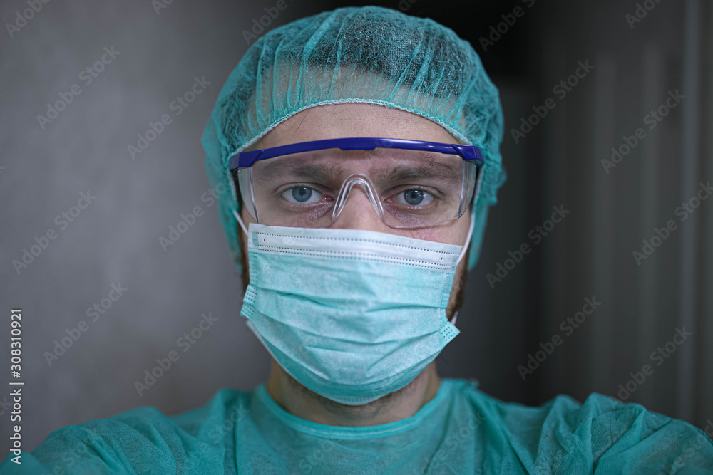 Portrait of a surgeon in uniform and glasses in the operating room. Portrait of a surgeon in uniform and glasses in the operating room.