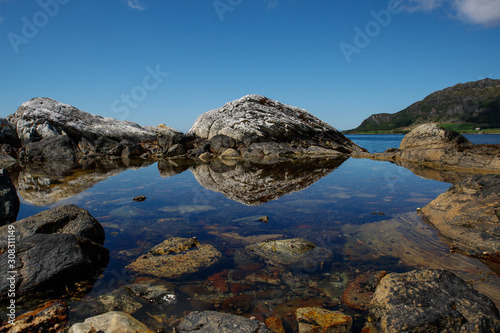 stone reflection in the water of the seaside