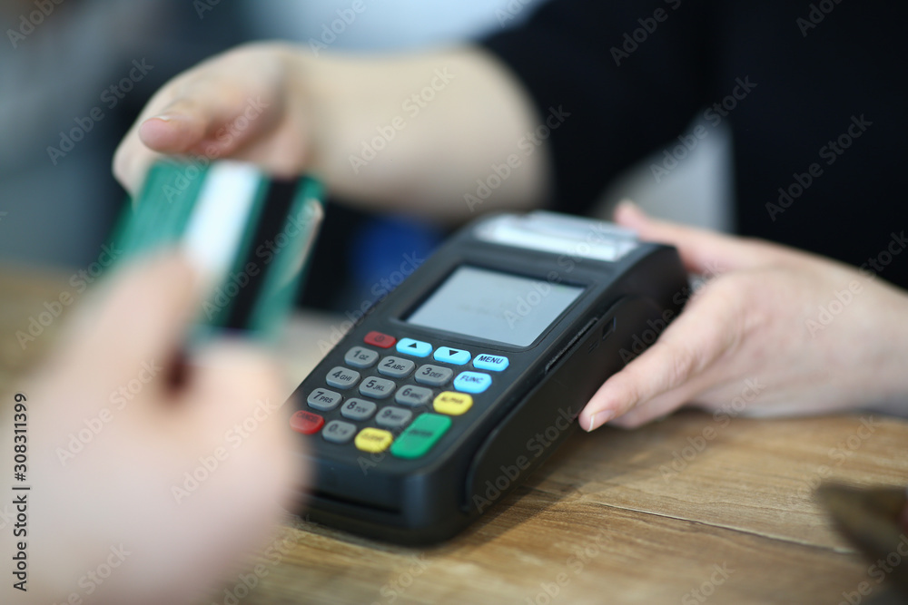 Cashier Hand Taking Plastic Credit Card to Payment Cashier Hand Taking Plastic Credit Card to Payment