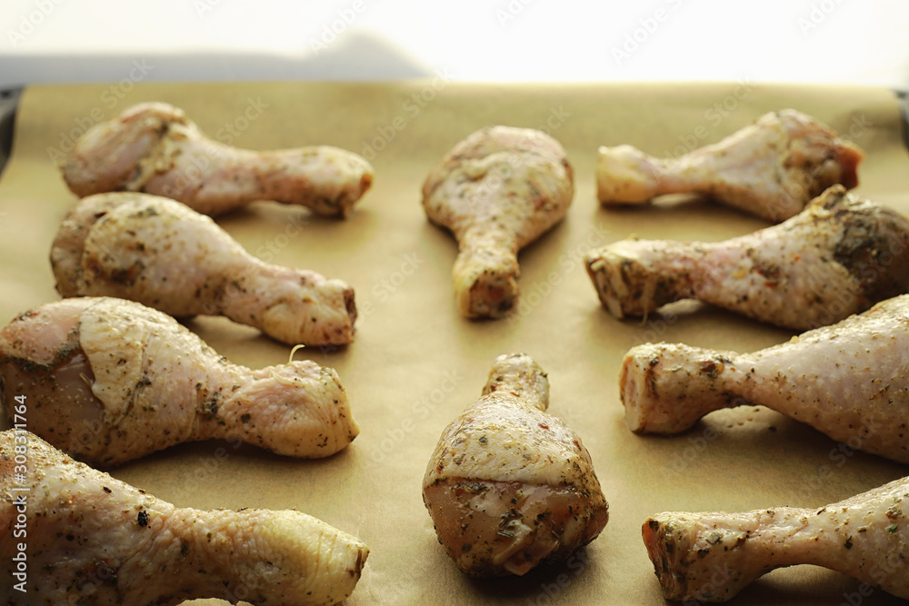 Fototapeta premium Baked chicken in the oven. Turkey legs on a baking sheet with spices baked in the oven. Snack on Thanksgiving Day.