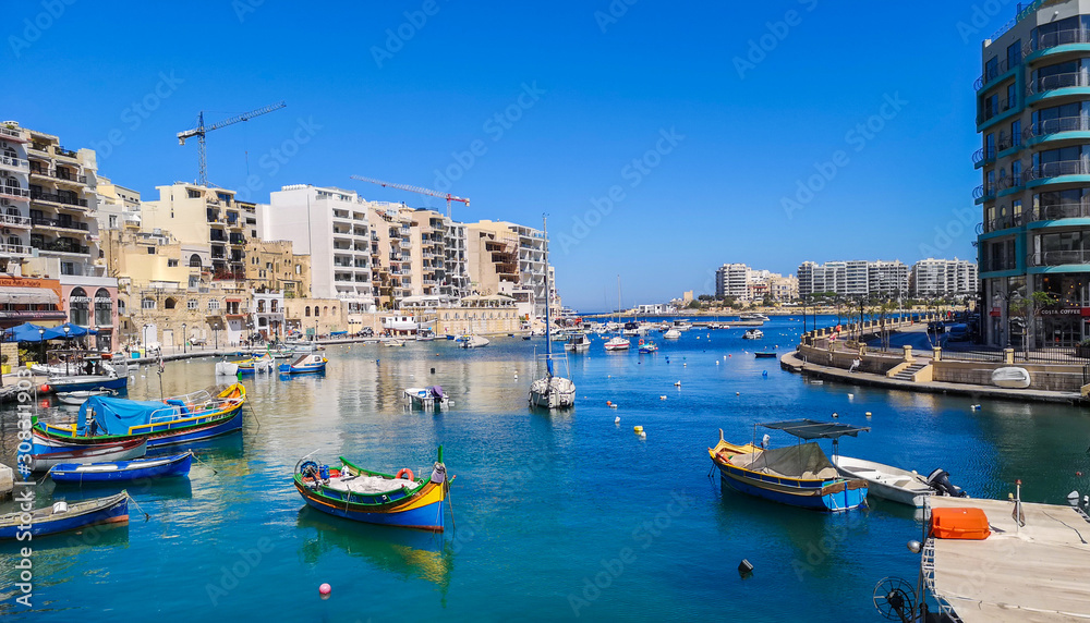 Spinola bay with fisher boats at St Julians, Malta