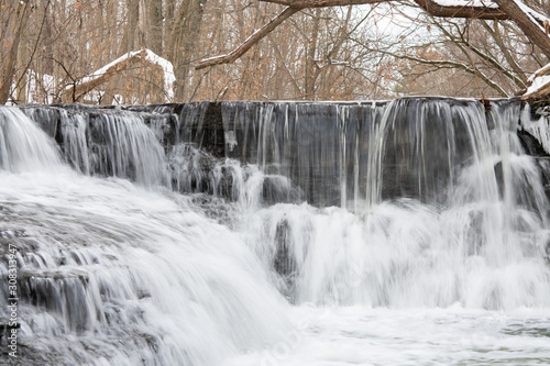 Small river cascade step on a winter 