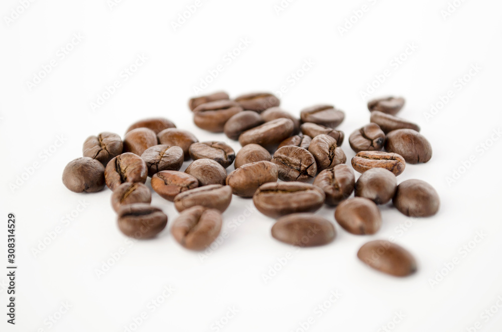 Coffee beans isolated on the white background. Grains of coffee close-up. Selective focus
