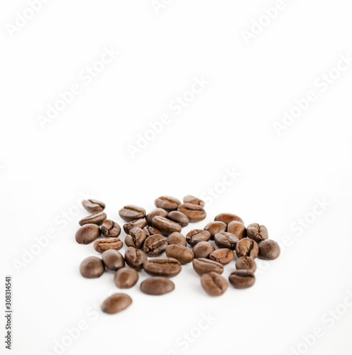 Coffee beans isolated on the white background. Grains of coffee with copy space close-up. Selective focus