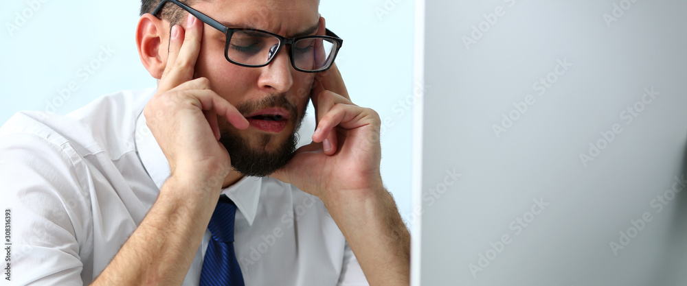 Tired clerk at laptop pc workplace wearing glasses Tired clerk at laptop pc workplace wearing glasses
