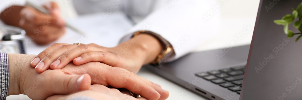 Friendly female doctor hold male patient Friendly female doctor hold male patient