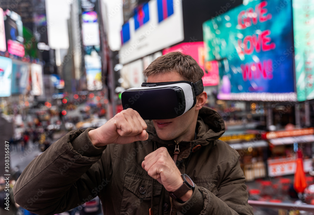 young man using VR in the city of new york young man using VR in the city of new york
