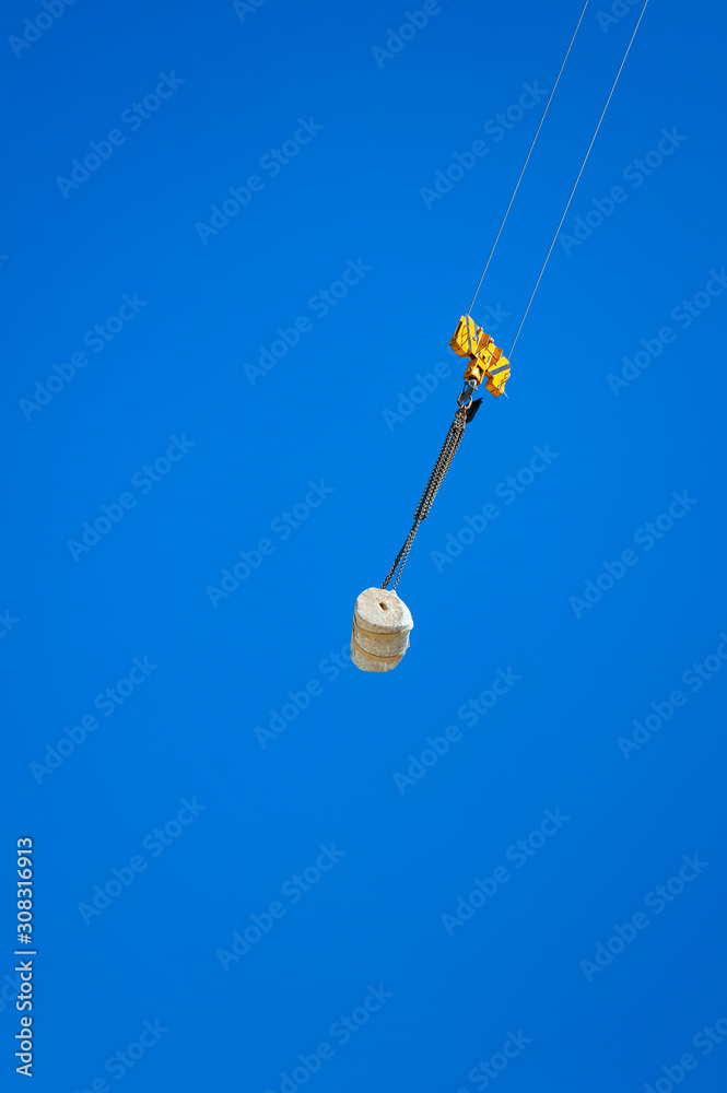 Crane lifting up a round stone. Crane lifting up a round stone.