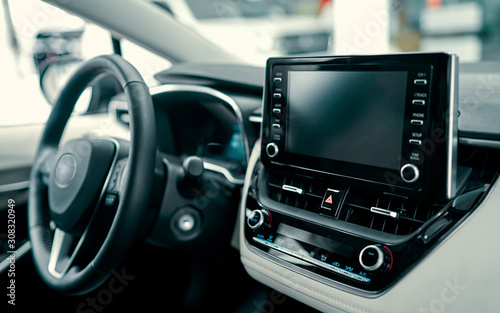 Luxury car interior. Steering wheel, shift lever and dashboard. © Valerii Apetroaiei