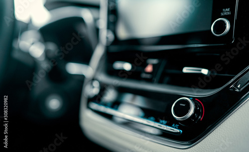 Close up luxury car interior. Steering wheel, shift lever and dashboard. © Valerii Apetroaiei