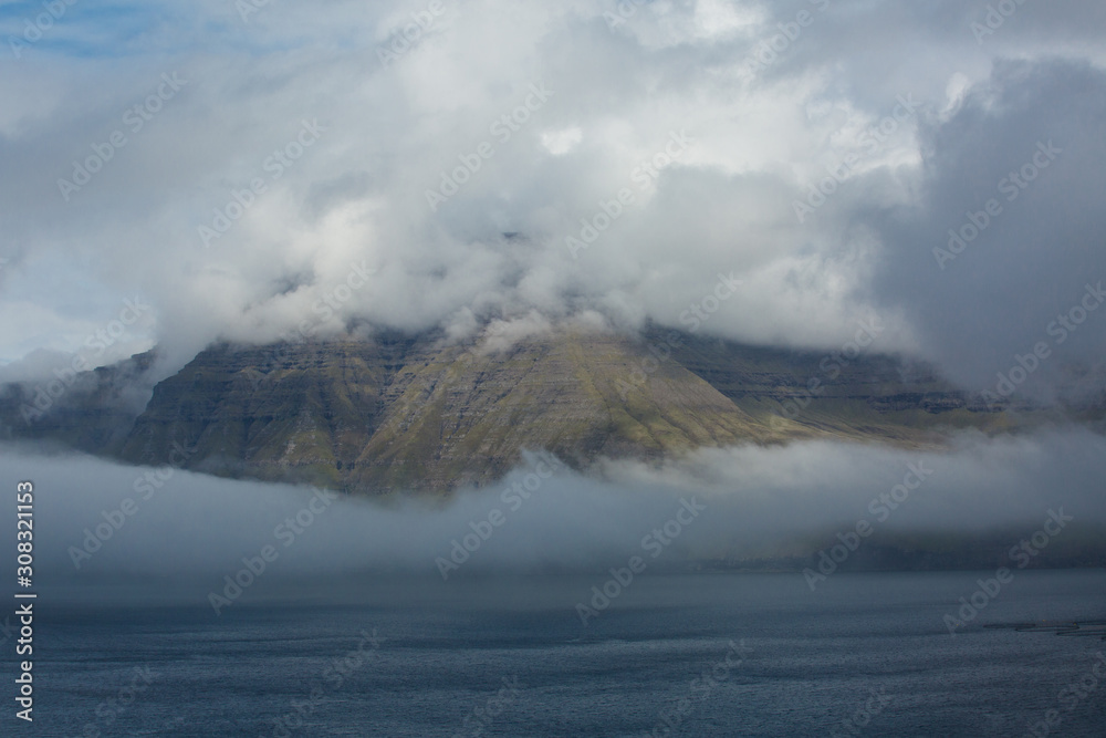 Clouds surrounding hills and mountains in the Faroe Islands