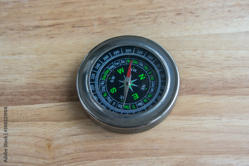 Compass on a wooden surface. Compass on a wooden surface.
