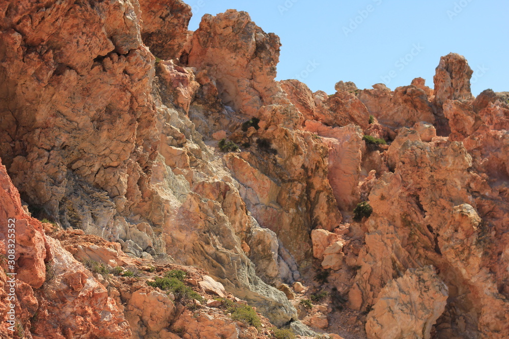 Volcanic rocky red cliffs in Milos, Greece