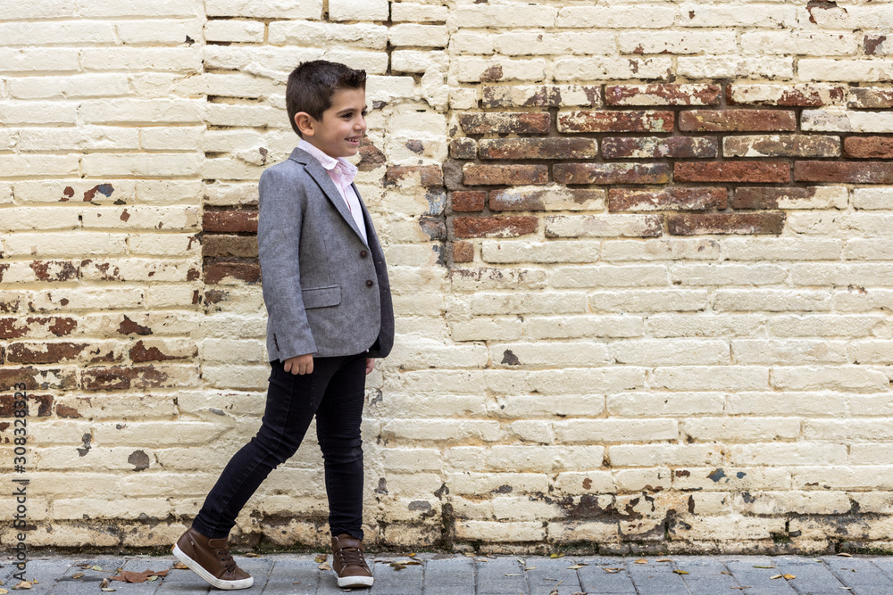Fashion little kid with a brick wall background Fashion little kid with a brick wall background
