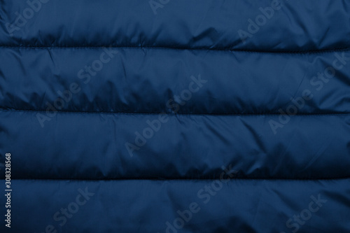 Blue puffer jacket texture. Down jacket fabric background.