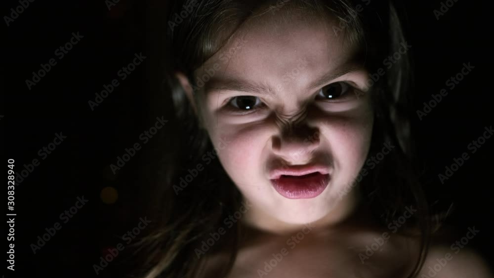 Face Of Little Girl Showing Scary Expression On Her Face. Face Of Little Girl Showing Scary Expression On Her Face.