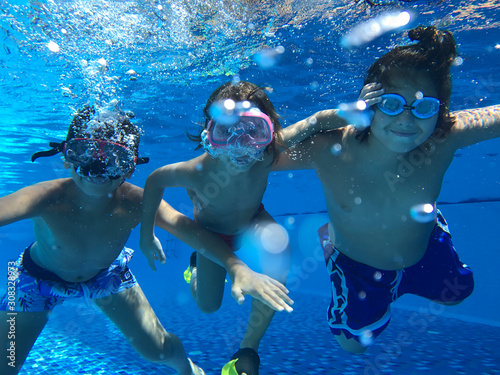 Kids enjoying in pool underwater