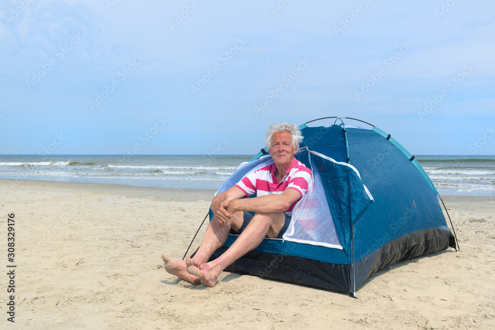 Man camping in shelter at the beach Man camping in shelter at the beach