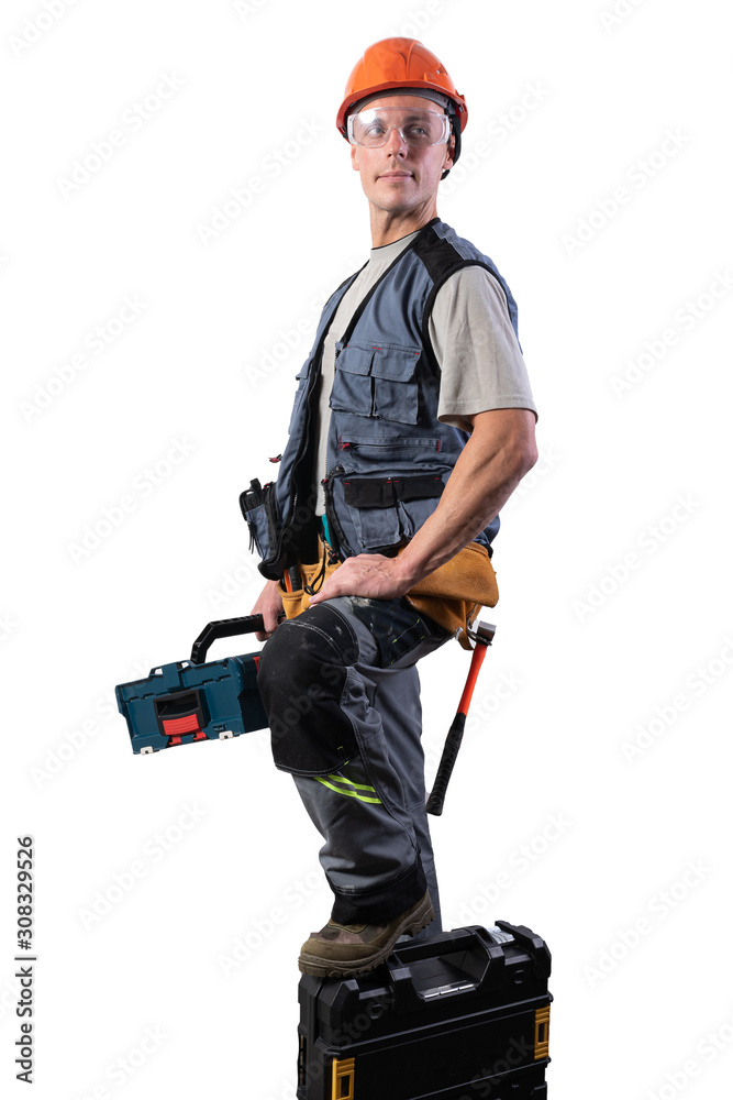 Builder with tools in cases. In a helmet and glasses, and unloading. Builder with tools in cases. In a helmet and glasses, and unloading.
