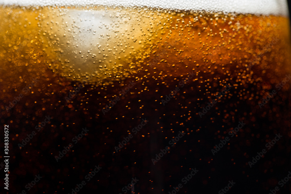 ice cubes on the background of cola, close-up. Black background ice cubes on the background of cola, close-up. Black background
