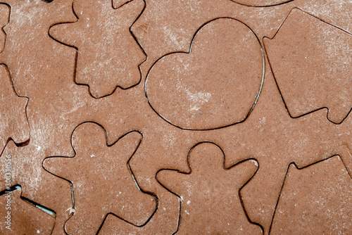 Baking gingerbread cookies, cutters with dough in flower form