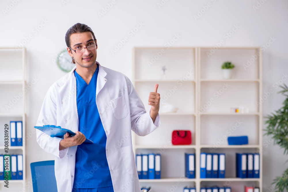 Young male doctor working in the clinic Young male doctor working in the clinic
