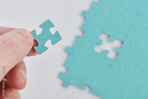Puzzle piece in hand