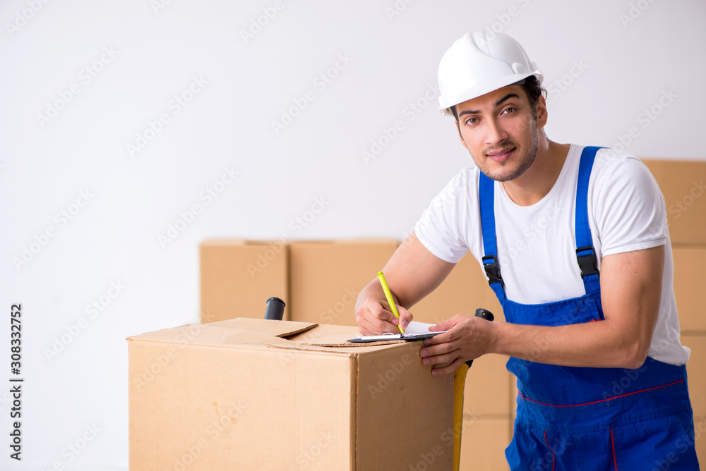 Young male professional mover doing home relocation Young male professional mover doing home relocation