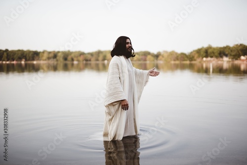 Jesus Christ walking in the water with his hand up Fototapet